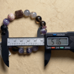 Creative Composition with Candle (Fire), Bronze (Metal), Water Scene