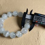 Minimalist Composition of Fluorite Bracelet with Water Drops on Glass