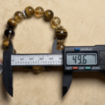Wood fossil bracelet displayed among stones and greenery, highlighting its organic origin and connection to the earth element.