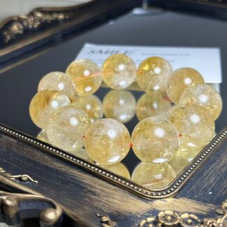 Macro shot of a Citrine bracelet bead, highlighting its natural internal textures and inclusions.