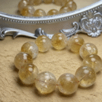 Natural Citrine bracelet styled with antique gold coins, symbolizing wealth attraction.