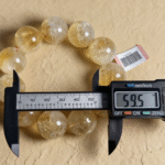 Natural Citrine bracelet styled with antique gold coins, symbolizing wealth attraction.