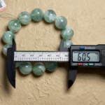 Still Life of Green Fluorite Bracelet with Plants and Books