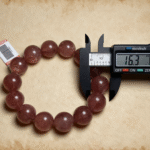 Strawberry Quartz with White Candle in Meditation Setup