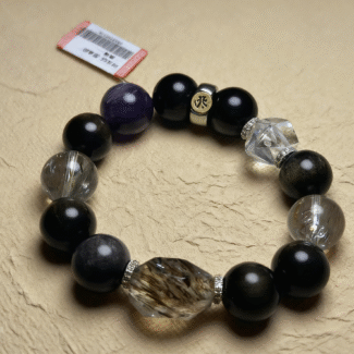 Amethyst bracelet close-up with deep purple hues and natural crystal formations, purple fabric background