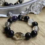 Artistic arrangement of all four crystal bracelets in circular formation, representing elemental cycle and unity