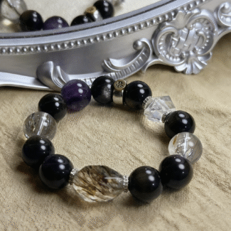 Artistic arrangement of all four crystal bracelets in circular formation, representing elemental cycle and unity