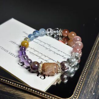 Fire element crystal bracelets featuring amethyst, strawberry quartz, sunstone and red rutilated quartz on red silk