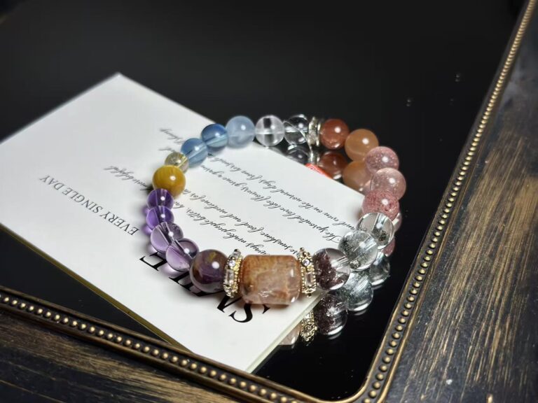 Fire element crystal bracelets featuring amethyst, strawberry quartz, sunstone and red rutilated quartz on red silk