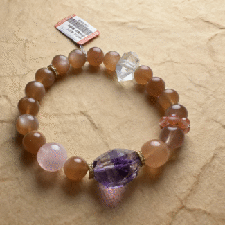 Close-up of sunstone bracelet with golden shimmer, captured on sunrise background for fire element energy