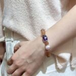 Herkimer diamond bracelet with transparent quartz points, arranged on geometric metal surface