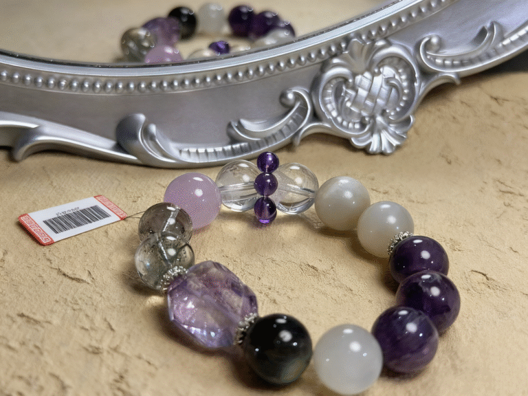 Kunzite bracelet with delicate pink-purple hues, displayed with fresh spring blossoms